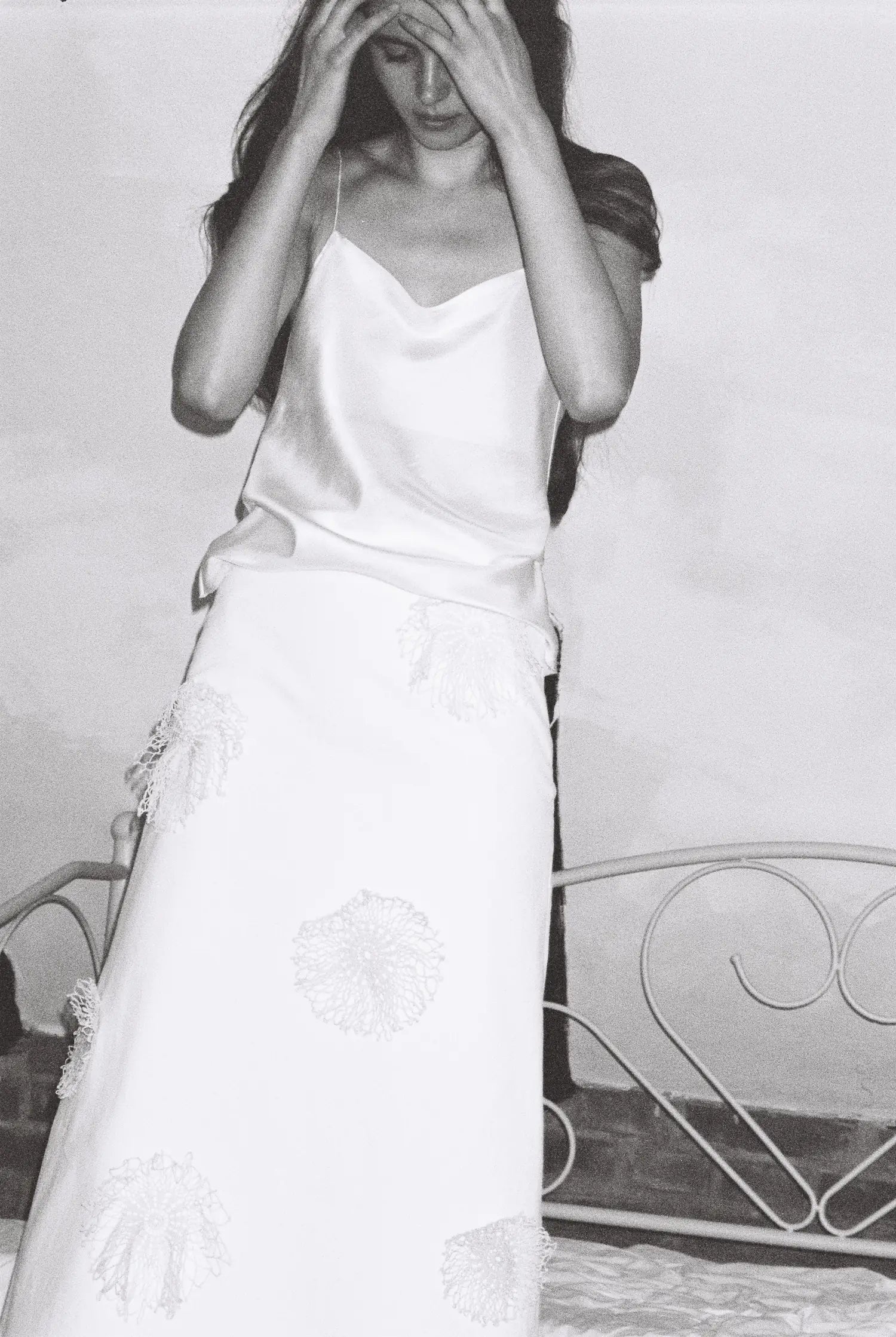 Model wearing a white silk top and a skirt from MAISON MAGDALENA
