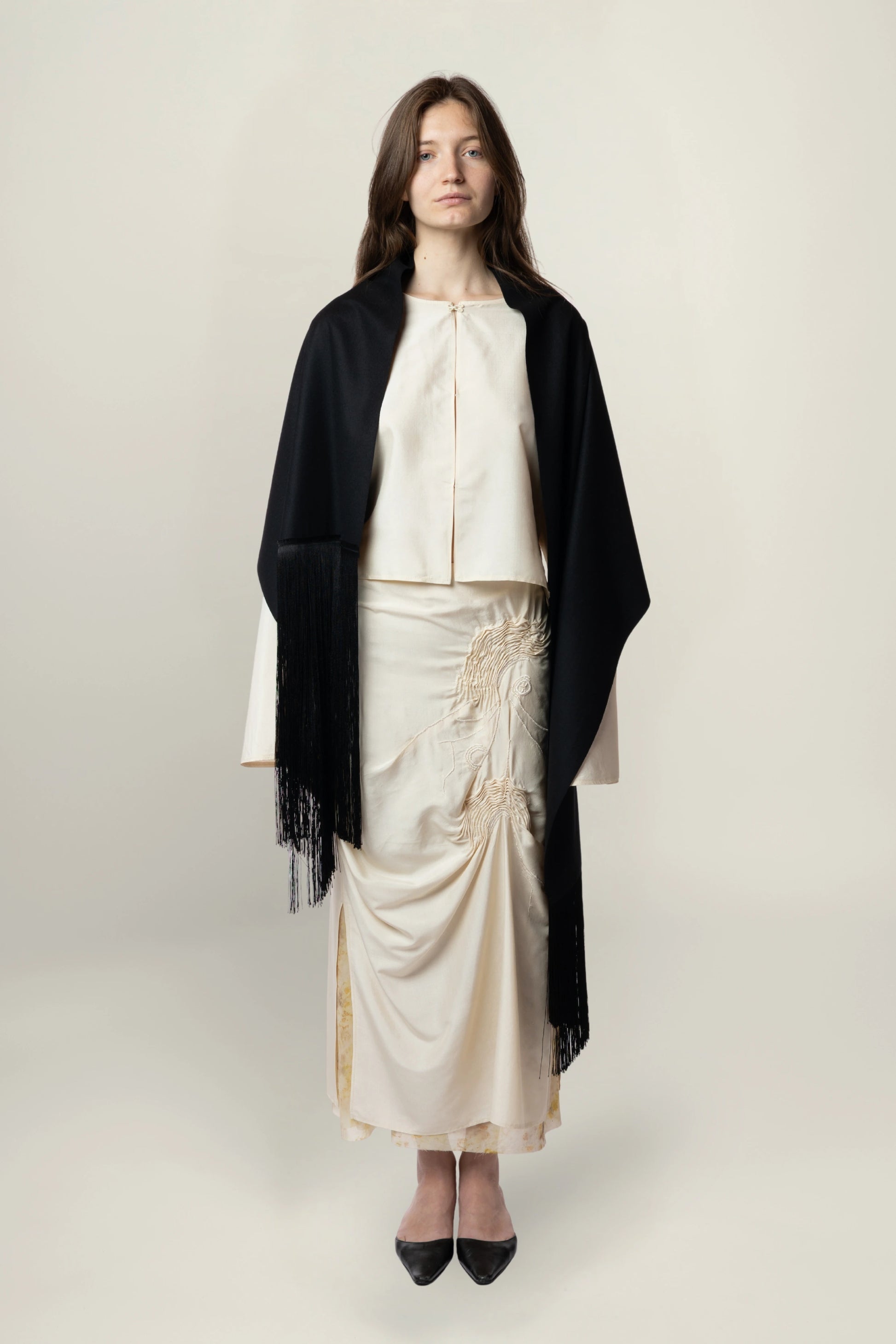 Brisa Scarf - Black | MAISON MAGDALENA | A long wool scarf with a handmade fringed finish | Model picture