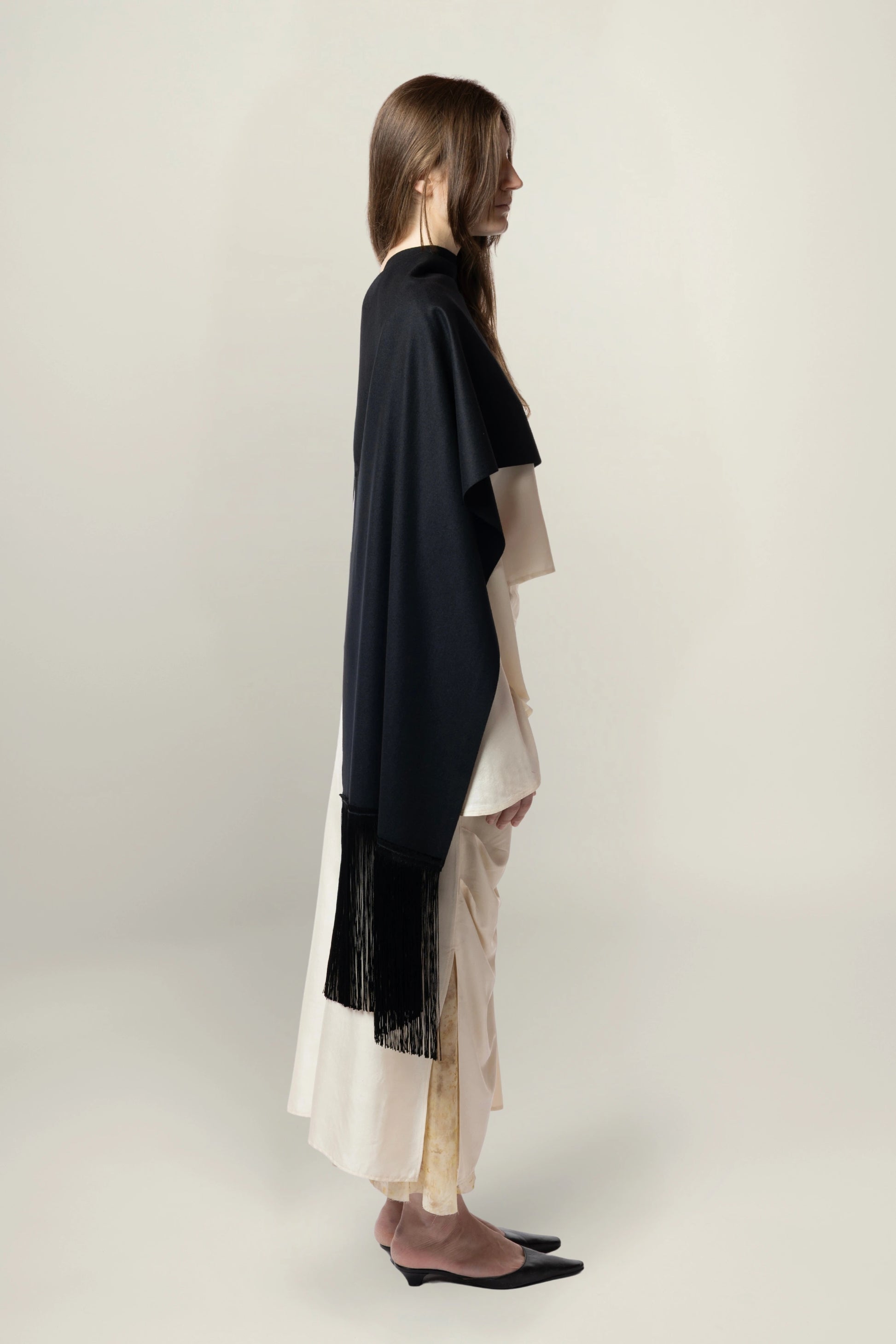 Brisa Scarf - Black | MAISON MAGDALENA | A long wool scarf with a handmade fringed finish | Model picture