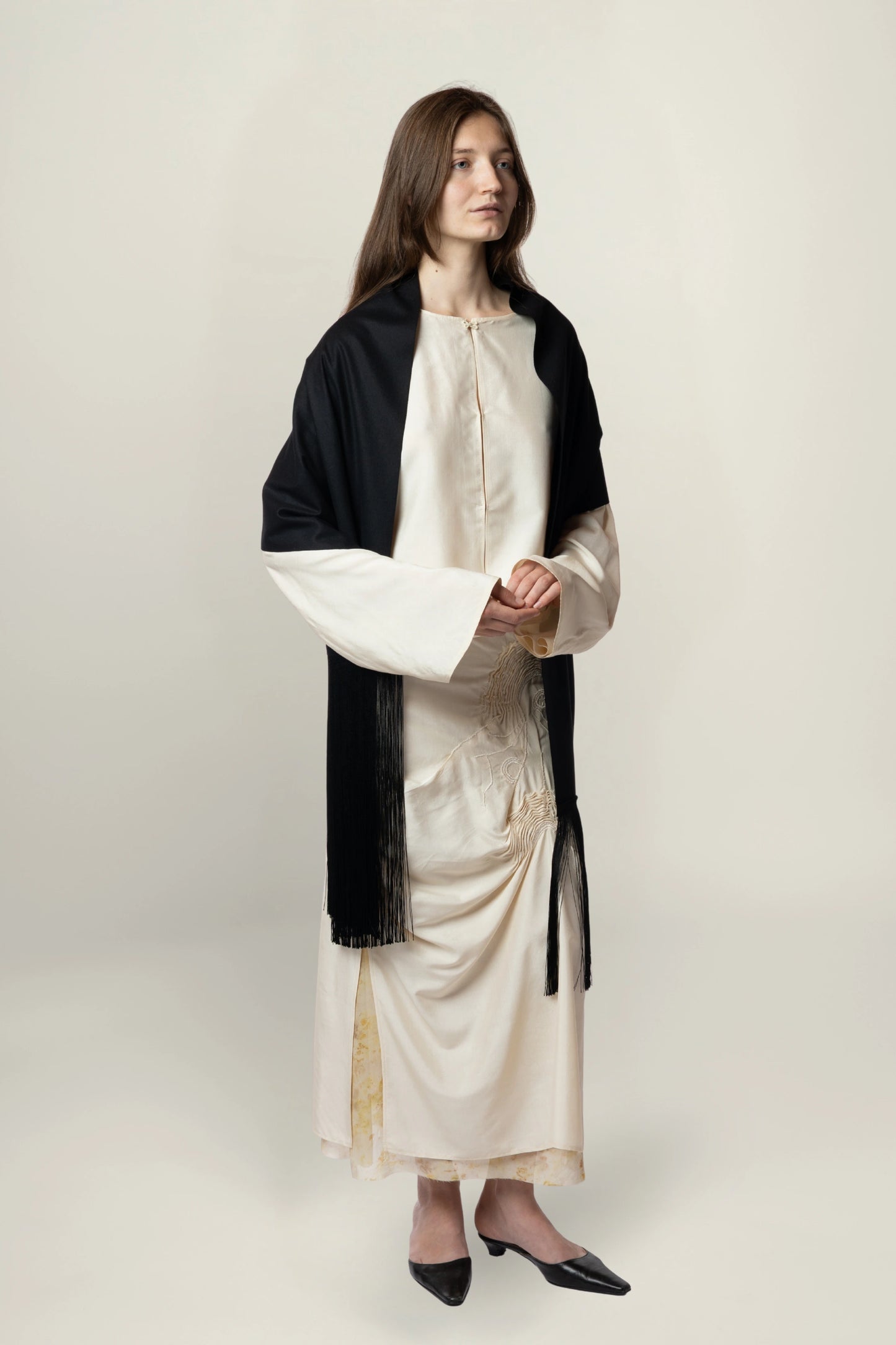 Brisa Scarf - Black | MAISON MAGDALENA | A long wool scarf with a handmade fringed finish | Model picture