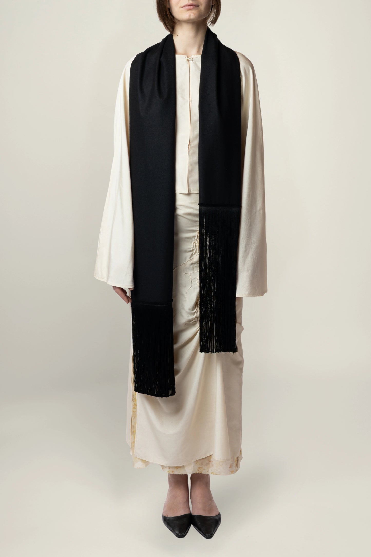 Brisa Scarf - Black | MAISON MAGDALENA | A long wool scarf with a handmade fringed finish | Model picture