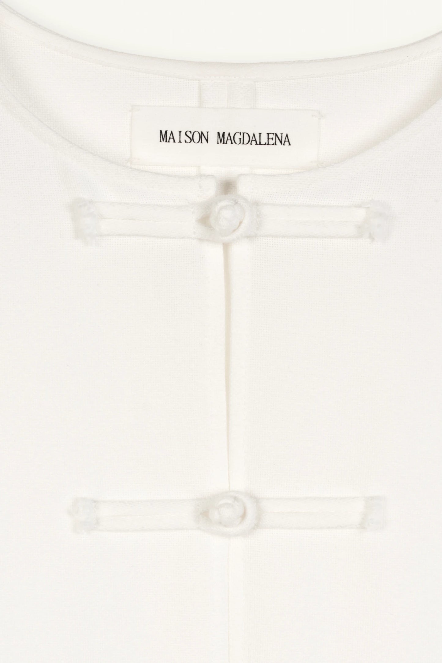 Cruise Top | Cruise Trousers | MAISON MAGDALENA | White top with handmade frog buttons | product picture close up on the buttons