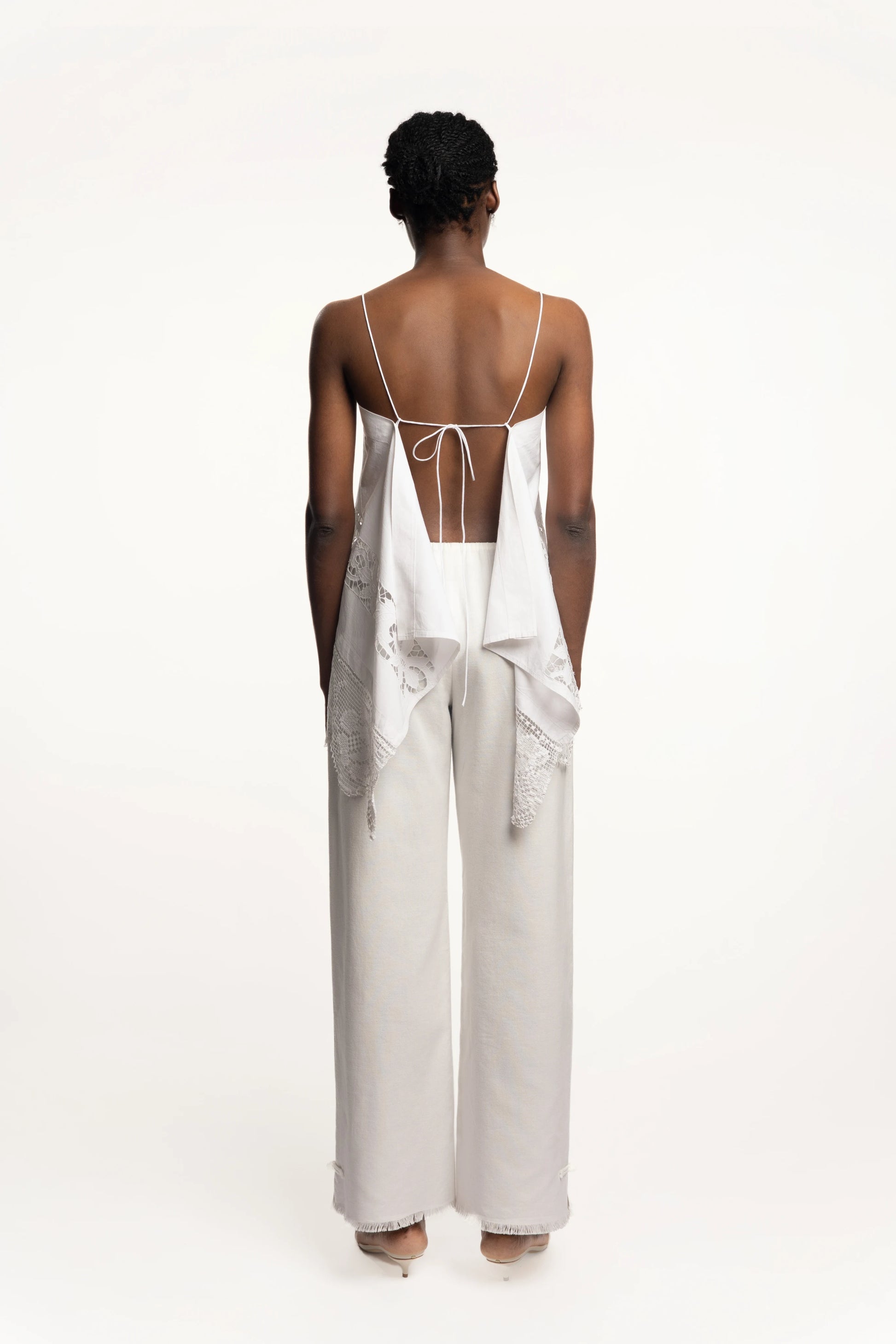 Cruise Trousers | MAISON MAGDALNEA | White cotton trousers with a handmade frog button as decoration at the bottom | Full model picture back view