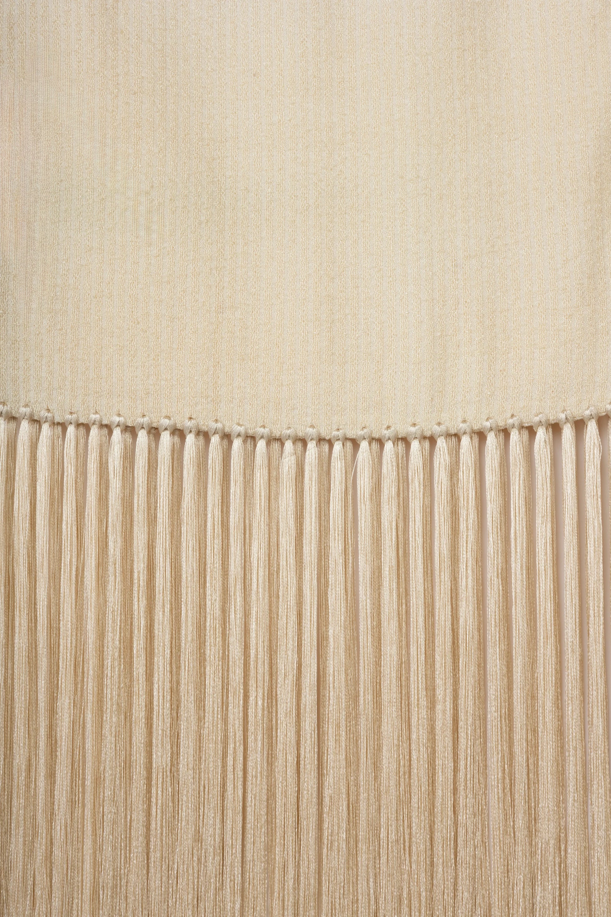 Linea Scarf | MAISON MAGDALENA | A beige long scarf with a handmade fringed finish | Detail picture