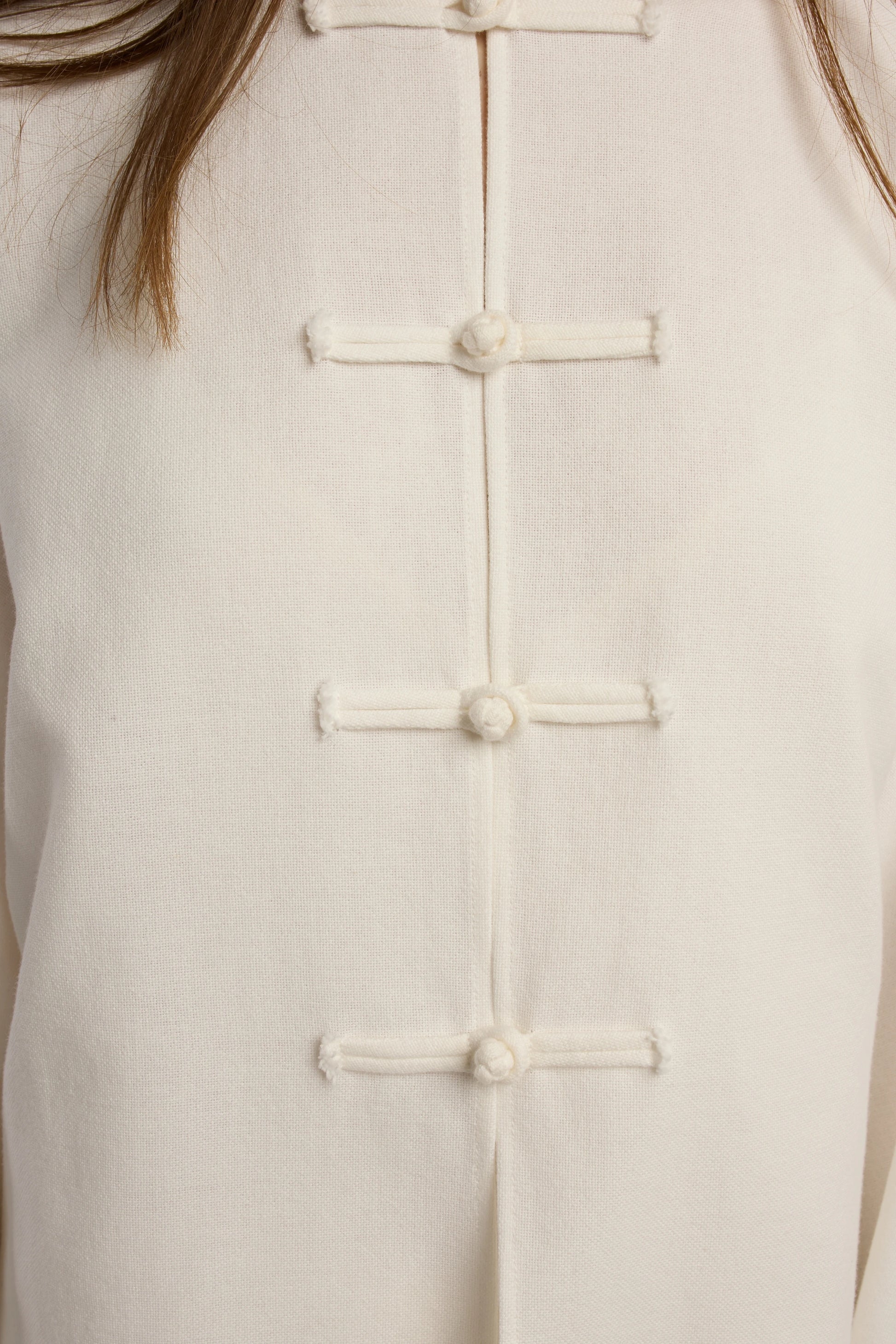 Cruise Top | MAISON MAGDALENA | White top with handmade frog buttons | Model picture button close up