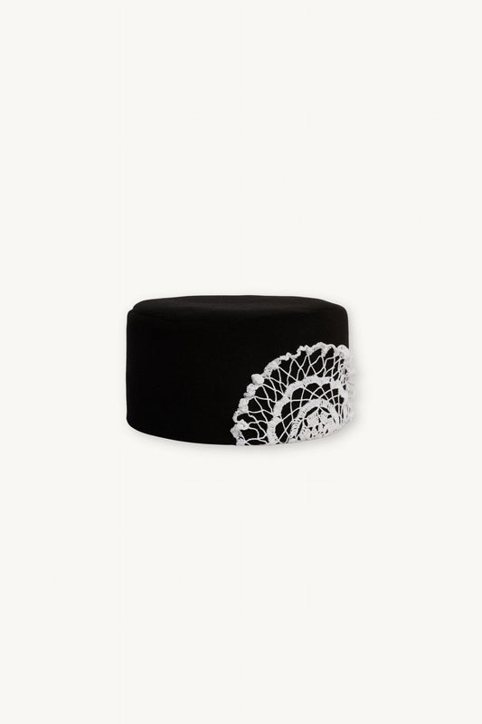 Ornis Hat | MAISON MAGDALENA | Black pillbox hat with a hand crocheted white flower on the side | Product picture front 