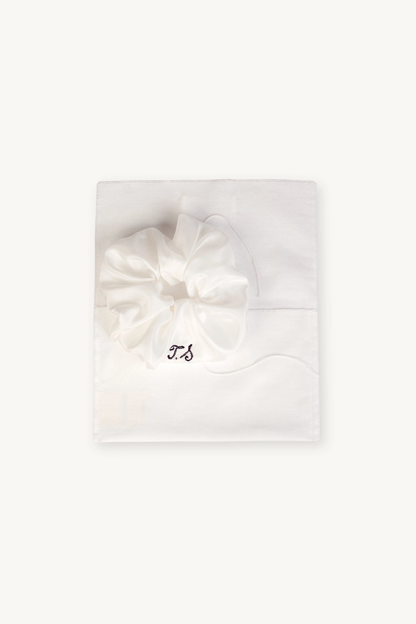 MAISON MAGDALENA | Antipasti Scrunchie with embroidered initials placed on a silk pocket
