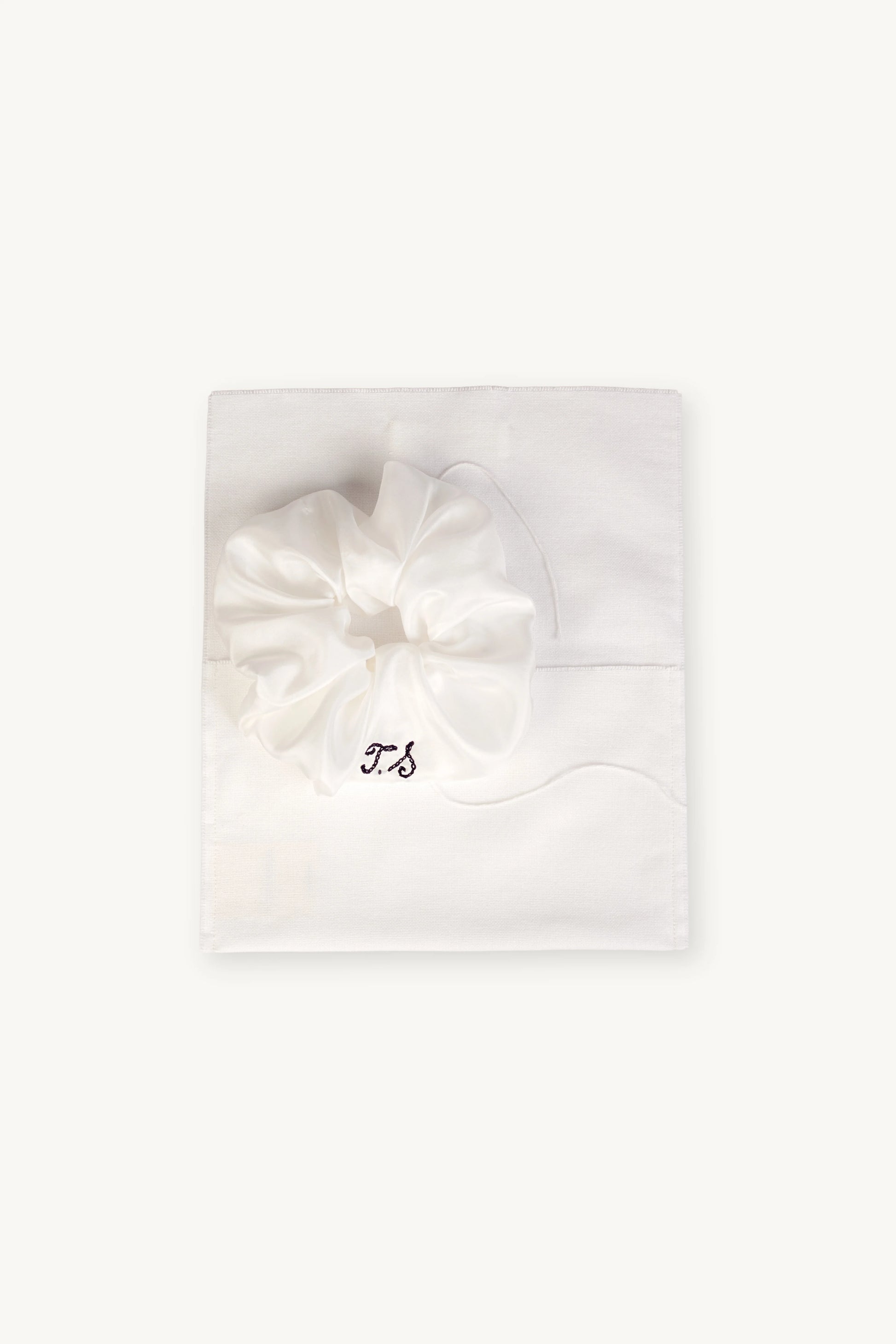 MAISON MAGDALENA | Antipasti Scrunchie with embroidered initials placed on a silk pocket